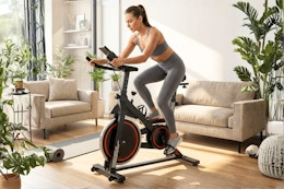 Lifestyle image of Naipo Exercise Bike being used indoors by a large window