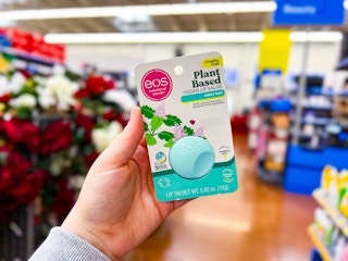 eos lip salve held up in front of check out area of Walmart store