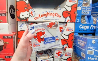 hand holding a pack of laughing cow cheese