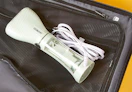 a green garment steamer in a suitcase 