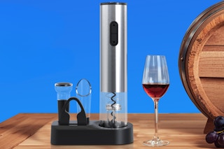electric wine opener next to a wine glass and barrell