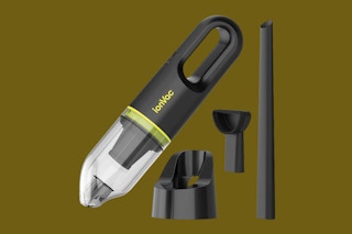 a handheld car vacuum on a dark green background