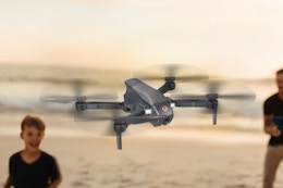 a man and child flying a drone