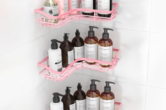 pink shower shelves in a corner