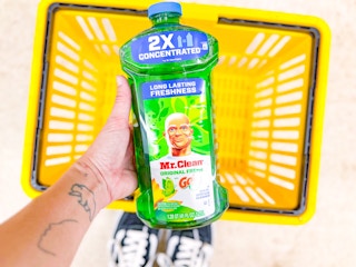 hand holding a bottle of mr. clean multi-surface cleaner