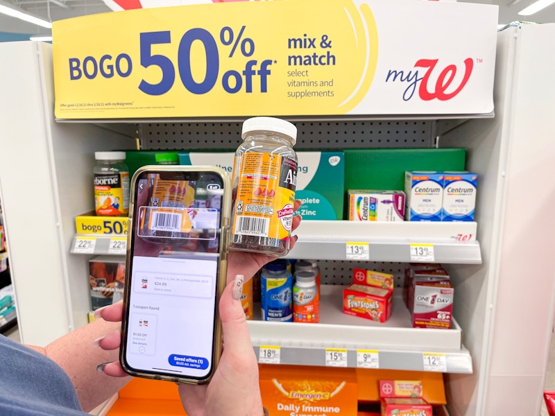 someone scanning vitamins on their phone in Walgreens