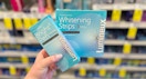 hand holding lumineux whitening strips in walgreens