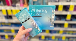 hand holding lumineux whitening strips in walgreens