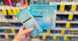 hand holding lumineux whitening strips in walgreens