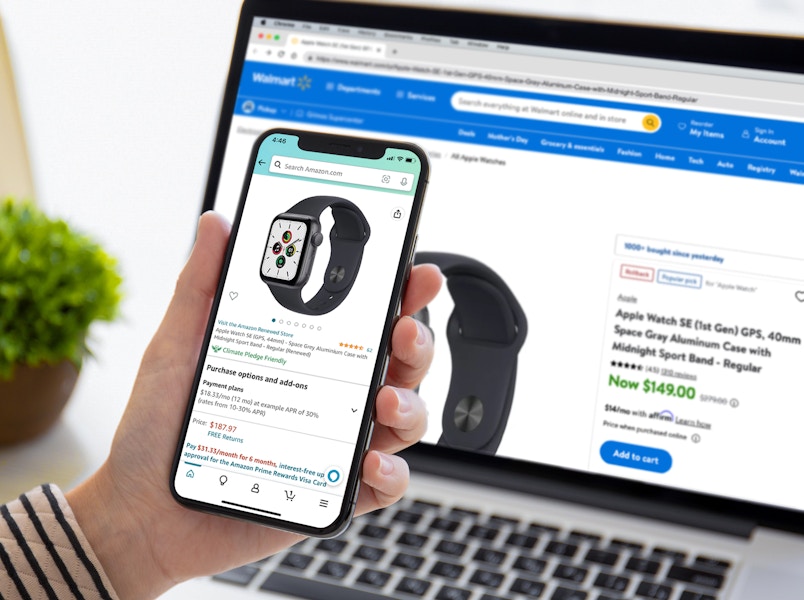 person comparing the price of an apple watch se on amazons app versus the walmart website