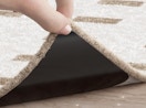 a rug gripper on the corner of a rug