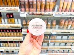 hand holding loreal blur-fection powder in walgreens