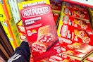 hand holding a box of hot pockets