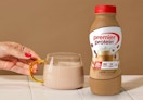 a bottle of Premier Protein next to a glass