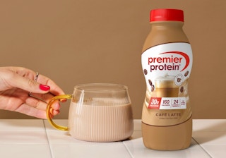 a bottle of Premier Protein next to a glass