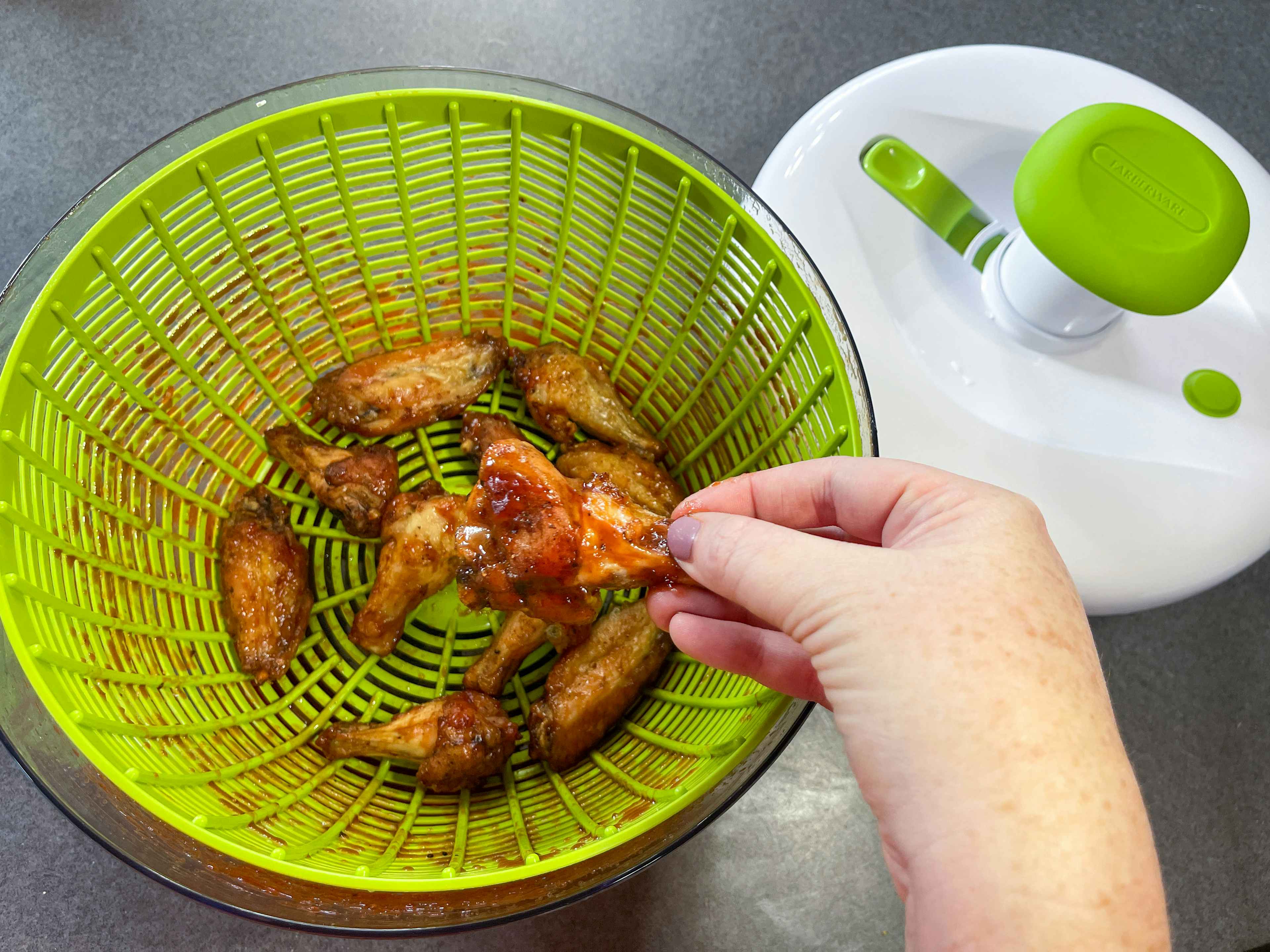 wings inside a salad spinner used to coat bbq sauce 
