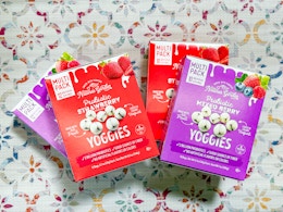 4 boxes of Yoggies with a patterned background (two 10-pack boxes and two 12-pack boxes)