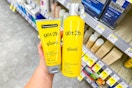 person holding got2b hair styling products by the shelf