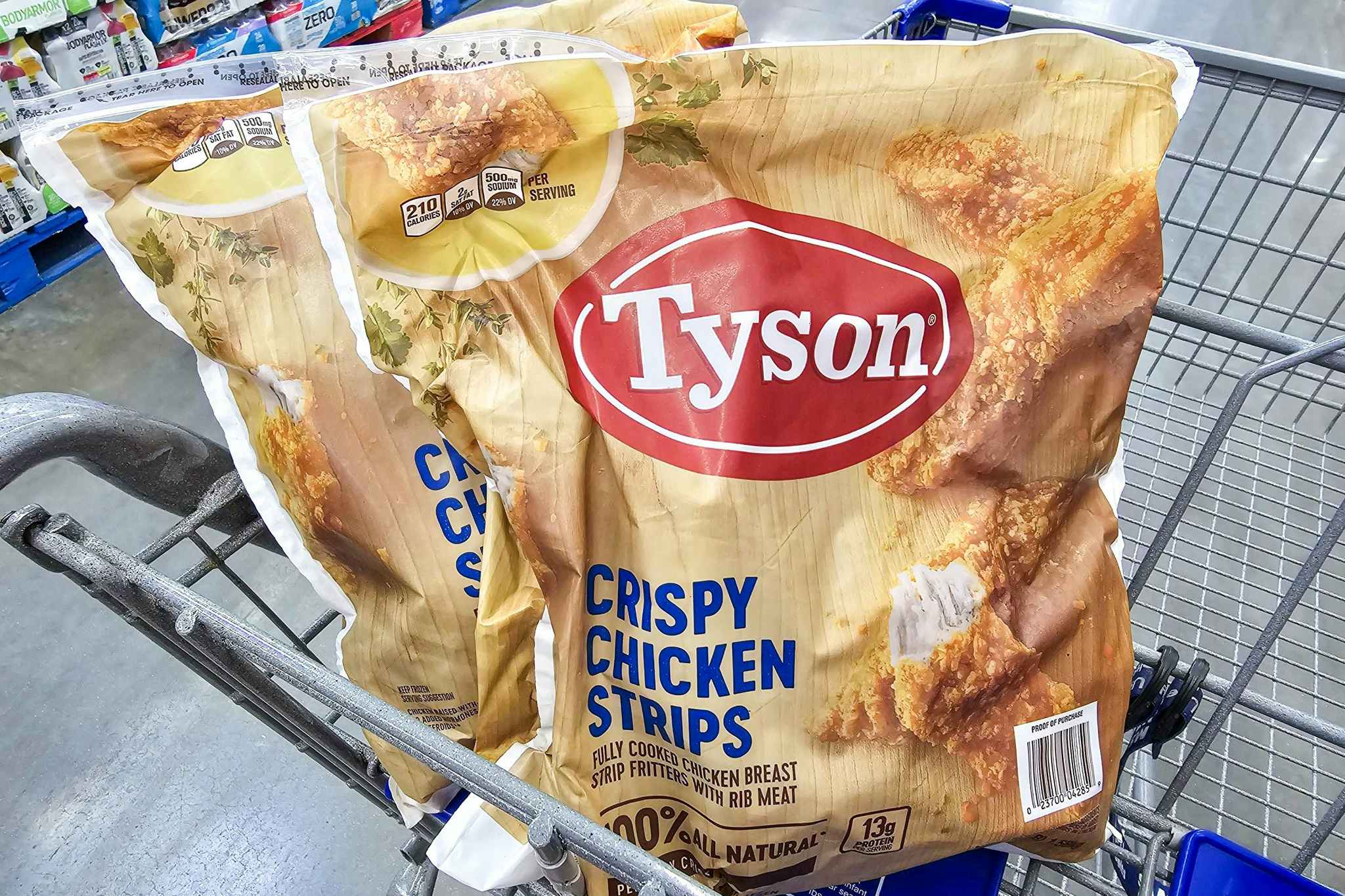 2 huge bags of tyson chicken strips in a shopping cart
