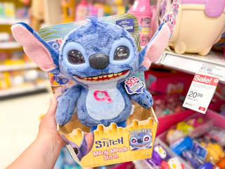 hand holding a disney stitch interactive plush in front a target shelf