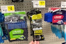 hand touching a pack of gillette black razors at dollar general