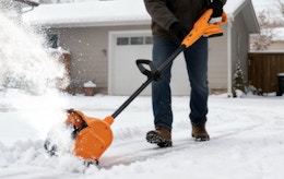 a person using an electric snow shovel