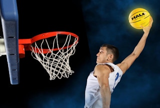a guy dunking a lit-up basketball
