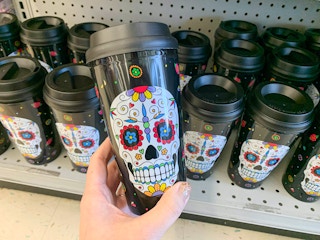 sugar skull to go tumbler held in front of other tumblers on shelf