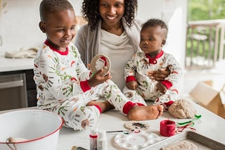 babies playing in the kitchen in burt's bees pajamas