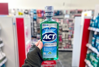 hand holding bottle of ACT mouthwash