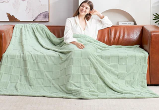 a ivory faux fur throw in a couch 