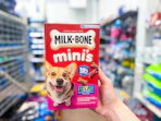 A box of Milk Bone Minis held up in Walmart store