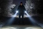 a man using flashlights