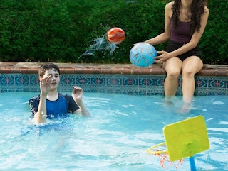 People throwing a ball in the pool