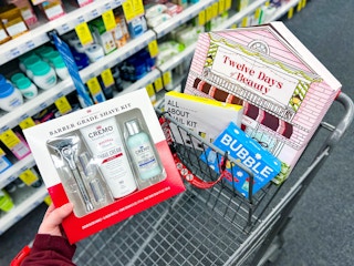 hand holding a cremo gift set over a shopping cart
