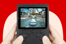 someone holding a retro gaming console