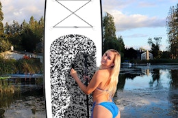 a woman standing next to her paddleboard