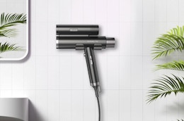 a dual hair dryer against a wall