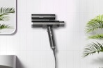 a dual hair dryer against a wall