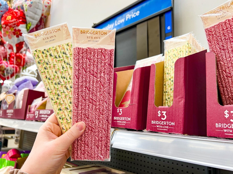 hand holding two packs of bridgerton straws at walmart