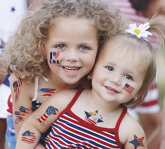 Two little girls with faux tattoos on their face