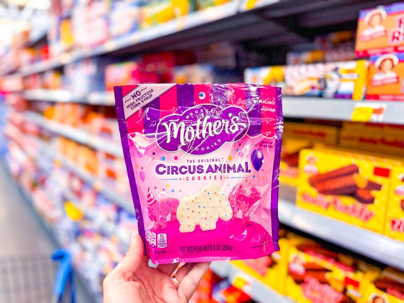 hand holding a bag of mothers circus animal cookies in walmart cookie aisle