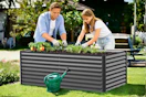Lifestyle image of a raised garden bed being used outdoors by two people