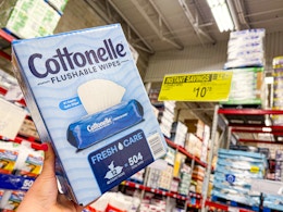hand holding a box of cottonelle wipes
