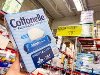 hand holding a box of cottonelle wipes