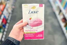 hand holding a pack of dove bar soap