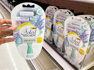hand holding up BIC razors in front of shelf at Target