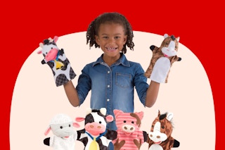 A young smiling girl holds up a cow and horse puppet. Below her are cow, horse, lamb, and pig puppets.