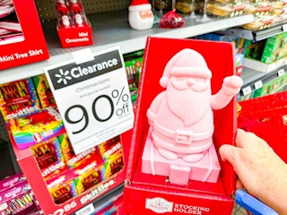 hand holding santa stocking holder in walmart aisle