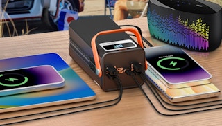 devices charging at a charging station on a wooden table
